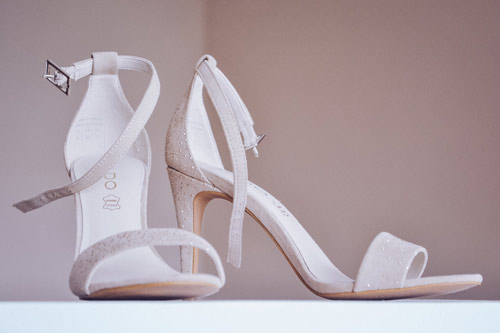 Image of a pair of white sparkly ankle strap heels denoting best party ankle strap heels to get in the spotlight.