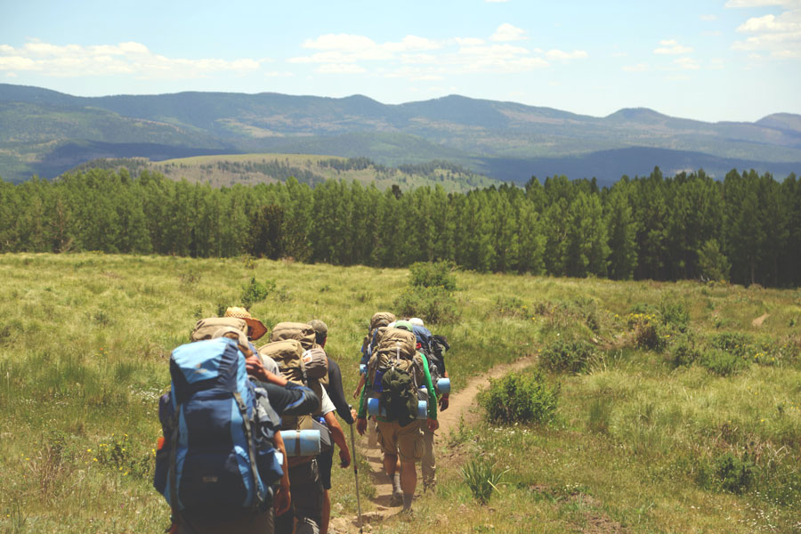 Image of a group of backpackers following a trail representing the nest backpacks for hiking