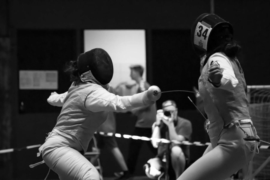 Two competitors fencing in a fencing match