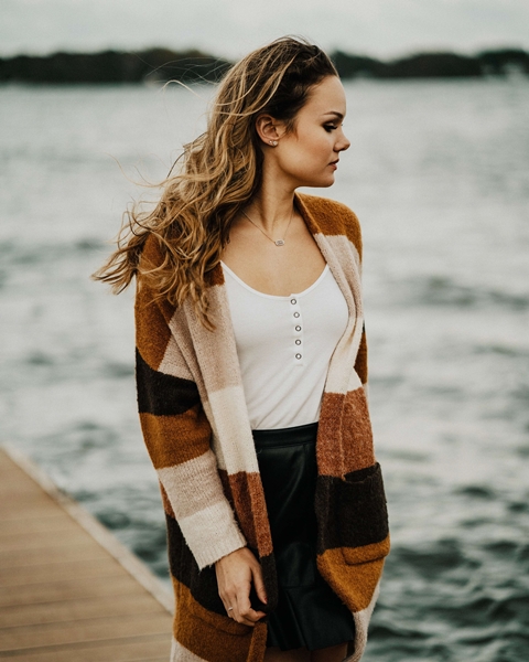 Image of a lady wearing wool knitted earthly colored cardigan depicting best women's cardigans for women to try on!