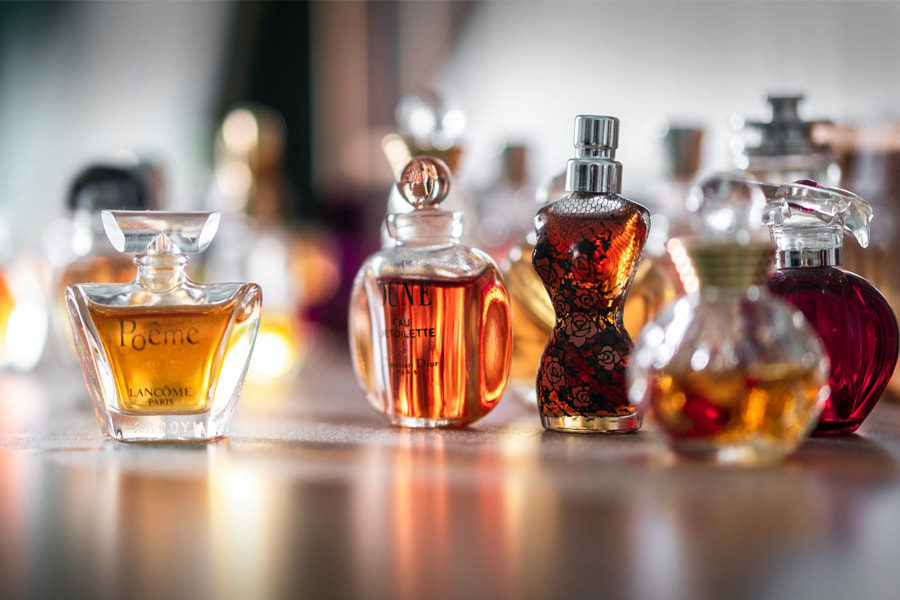 A few perfumes kept on a table depicting all you need to know about the production of aromas