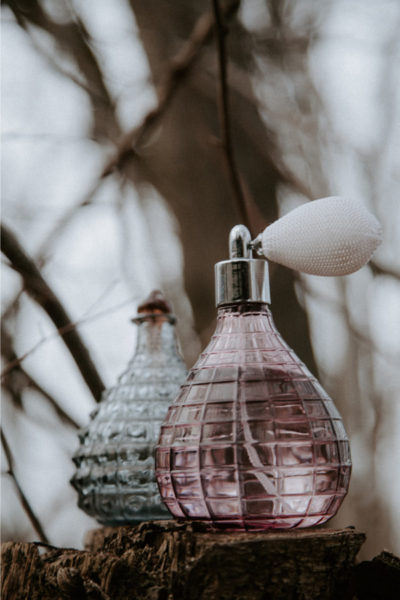 Two bottles of perfumes denoting the history of perfumes