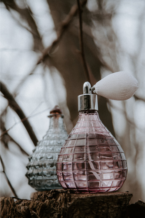 Two bottles of perfumes denoting the history of perfume industry