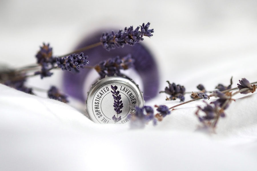 Image of a lavender oil bottled surrounded with lavender flowers