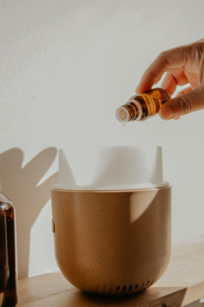 Image of adding sandalwood essential oil to a diffuser