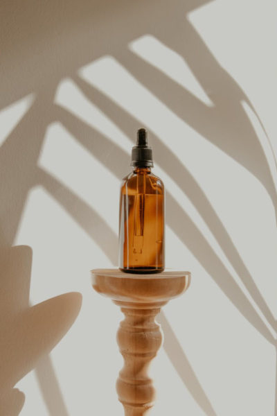 Image of a bottle of grapeseed oil kept on a stool