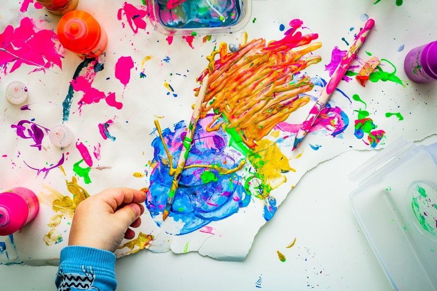 Image of a kid painting with vibrant colors depicting best art sets for kids