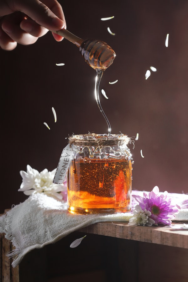 Image of a clear glass jar full of raw honey
