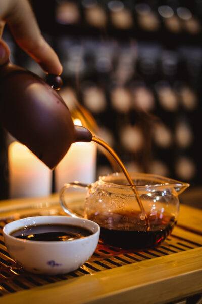 Image of a person pouring black tea from a kettle depicting the health benefits of black tea